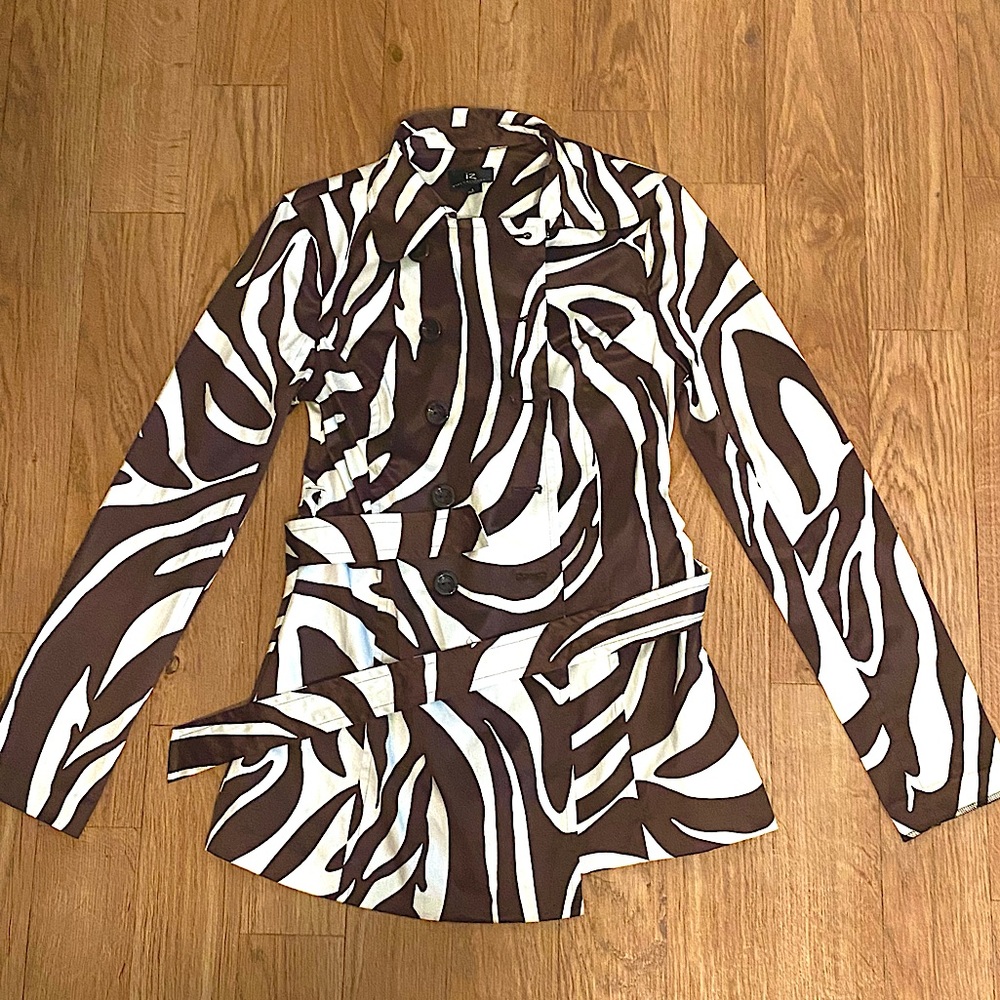 Zebra print coat in good condition. Made of polyester, cotton, and spandex.